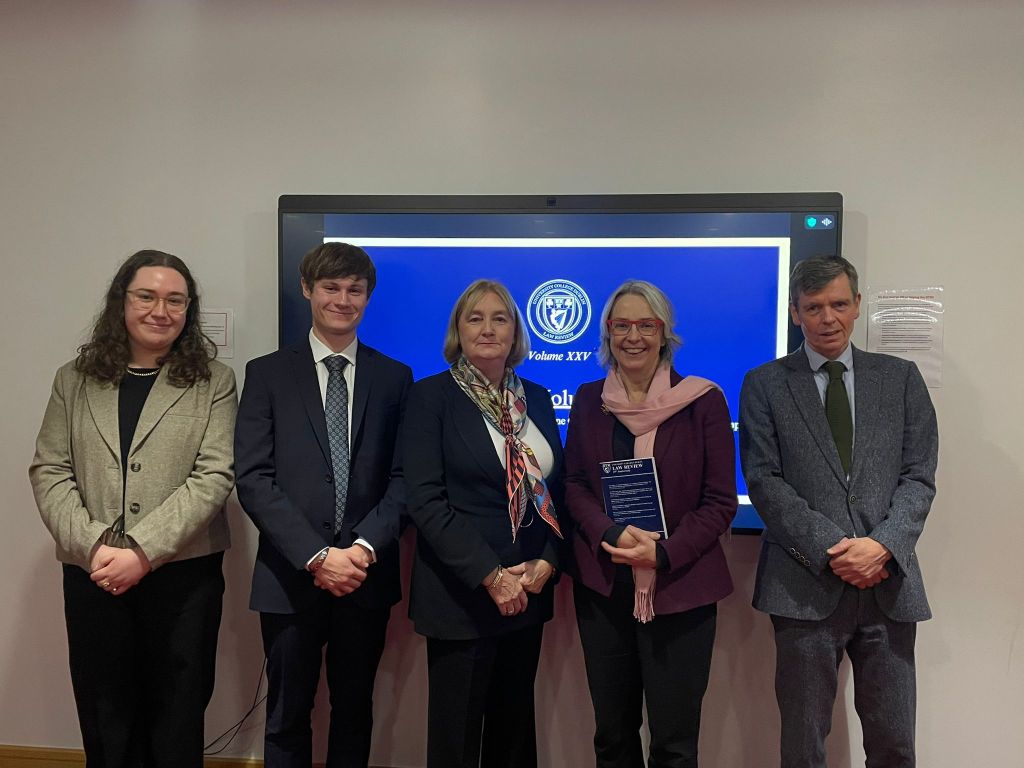 Group photo of the UCD Law Review team members at the launch of Volume XXV, featuring five individuals standing in front of a presentation screen.