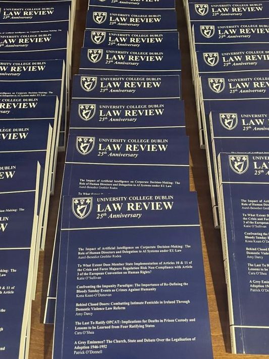 A table displaying multiple copies of the UCD Law Review Volume 25, featuring a blue cover with the title 'Law Review' and '25th Anniversary.'